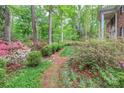 Expansive yard with mature trees and flowering bushes, offering a serene outdoor space at 715 Saint Cloud Dr, Statesville, NC 28625