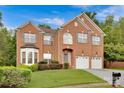 Brick two-story house with a two-car garage and landscaped lawn at 1801 Briarcrest Dr, Charlotte, NC 28269