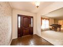 Inviting foyer with tile flooring, a decorative front door and sidelights, and an adjacent living space at 370 21St Nw Ave, Hickory, NC 28601