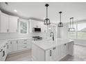 A modern kitchen with a central island, white cabinets, and pendant lighting at 117 Hatford Ct, Statesville, NC 28625