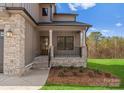 Charming covered front porch with stone pillars and iron railing, offering a welcoming entrance to the home at 171 Heartland Dr # 7, Rock Hill, SC 29732