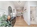 Elegant entryway with chandelier, console table with decor, and view into the living and dining areas at 199 Heartland Dr # 10, Rock Hill, SC 29732