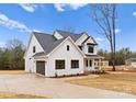 Elegant two-story white farmhouse-style home with a two car garage and freshly planted landscaping at 199 Heartland Dr # 10, Rock Hill, SC 29732