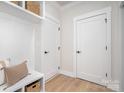 Well-organized mudroom features built-in storage, bench seating and neutral decor with wood floors at 199 Heartland Dr # 10, Rock Hill, SC 29732