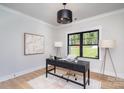 Bright office space with a modern desk, artwork, and a view of the front yard from the window at 199 Heartland Dr # 10, Rock Hill, SC 29732