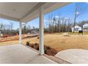 Covered porch featuring concrete flooring, classic white columns, and views of the neighborhood at 199 Heartland Dr # 10, Rock Hill, SC 29732