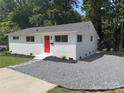 Newly renovated white brick ranch home with a red door at 2600 Alleghany St, Charlotte, NC 28208