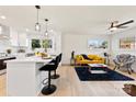 Open concept living area with white kitchen and yellow couch at 2600 Alleghany St, Charlotte, NC 28208