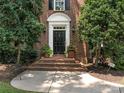 Elegant front entry with black door and brick steps at 4301 Fairview Oaks Dr, Charlotte, NC 28211