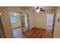 Bright bedroom with laminate wood flooring, ceiling fan, and sliding glass doors at 12608 Rocky River Church Rd, Charlotte, NC 28215