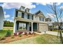 Two-story home featuring a two-car garage, stone accents, and a welcoming front porch at 8736 Acadia Pkwy # 601, Sherrills Ford, NC 28673