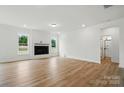 Spacious living room with wood floors, a fireplace, white walls, and abundant natural light at 8736 Acadia Pkwy # 601, Sherrills Ford, NC 28673