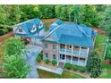 Stunning aerial view of the property showcasing the brick home and two car detached garage at 5888 Hidden Oaks Ln, Clover, SC 29710