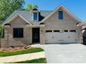 Charming brick home featuring a two-car garage and freshly landscaped front yard at 5106 Silver Trace Ln # 90, Denver, NC 28037