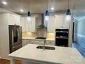 Modern kitchen featuring stainless steel appliances, white cabinetry, and stylish pendant lighting at 5106 Silver Trace Ln # 90, Denver, NC 28037