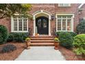 Elegant front entry with brick steps and landscaping at 7025 Willow Trace Ln, Weddington, NC 28104