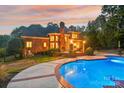 Inviting pool and patio area at sunset at 7025 Willow Trace Ln, Weddington, NC 28104