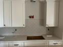 White shaker cabinets, quartz countertops, and neutral backsplash at 94 Sterling Branch Loop # 94, Denver, NC 28037