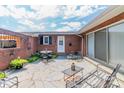Cozy backyard patio with stone flooring, brick accents, and comfortable outdoor seating at 1405 Northcrest Dr, Albemarle, NC 28001