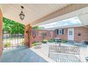 Secluded backyard patio with stone flooring, wrought iron furniture, and access to the home's interior at 1405 Northcrest Dr, Albemarle, NC 28001
