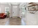 Bright and airy entryway with wood-look floors and access to other rooms at 14949 Holbrooks Rd, Huntersville, NC 28078