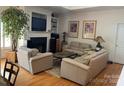 Cozy living room with hardwood floors, fireplace, and comfortable seating at 19307 Beaufain St, Cornelius, NC 28031