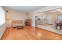 Cozy living room with hardwood floors and an archway leading to the kitchen and dining area at 1206 Mineral Springs Rd, Charlotte, NC 28262