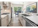 Bright, modern kitchen with stainless steel appliances, farmhouse sink, and outdoor view at 4861 Blanchard Way, Charlotte, NC 28226