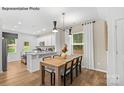 Kitchen dining area with a light wood table and four chairs at 8104 Haidas Ave # 036, Charlotte, NC 28214