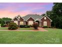 Charming brick home with manicured lawn, mature landscaping, and warm inviting curb appeal at 720 Miller Chapel Rd, Salisbury, NC 28147