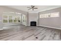 Bright living room features a fireplace, large windows, and wood flooring at 2009 Atherton Dr, Indian Trail, NC 28079