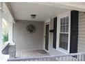 Inviting front porch features stone-accented columns, a wreath, and a storm door at 436 E Oakwood Ave, Albemarle, NC 28001