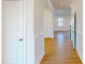 Bright hallway with hardwood floors, white trim, and neutral paint offering a modern aesthetic at 10108 Whitaker Pointe Dr, Huntersville, NC 28078