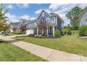 Two-story home with front porch and landscaped yard at 1180 Weir Ct, Fort Mill, SC 29708