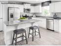 Modern kitchen featuring stainless steel appliances, granite countertops, and a kitchen island with seating at 467 Hollis Dr # 0055, Lancaster, SC 29720