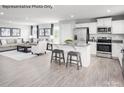 Open-concept living space with a kitchen island, stainless appliances, and a connected sitting area at 467 Hollis Dr # 0055, Lancaster, SC 29720