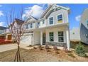 Inviting two-story home featuring stone accents, a covered porch, and a well-maintained front yard at 2008 Embassy Ct # 45, Charlotte, NC 28213