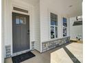 Welcoming front porch showcasing the stylish front door, windows and stone accents at 2008 Embassy Ct # 45, Charlotte, NC 28213
