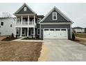 Charming two-story home with a spacious two-car garage and covered porch at 3253 Mcharney Dr # 27, Harrisburg, NC 28075