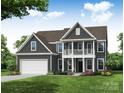 Two story house with gray siding, white garage door, and landscaping at 3253 Mcharney Dr # 27, Harrisburg, NC 28075