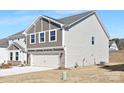 This home features a light gray color, a grey shake accent, and a two-car garage at 121 Saidin Ln, Troutman, NC 28166