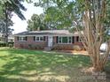 Traditional brick home with a well-maintained lawn and tidy landscaping in a suburban setting at 611 Greenbriar Ave, Rock Hill, SC 29730