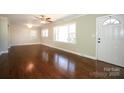 Spacious living room featuring hardwood floors, ceiling fan, and a large window for natural light at 611 Greenbriar Ave, Rock Hill, SC 29730