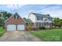 Charming brick and siding home with a well-manicured lawn and two-car garage at 106 Cameron Dr, Kings Mountain, NC 28086