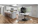 Modern kitchen with white cabinets, breakfast bar, and a black fridge at 4972 Mayble St, Catawba, NC 28609