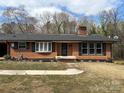 Charming brick home featuring a well-maintained front yard and inviting entrance at 110 Spruce Dr, Salisbury, NC 28147