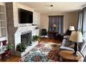 Cozy living room with a fireplace, hardwood floors, and stylish decor at 110 Spruce Dr, Salisbury, NC 28147