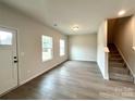 Bright and airy living room with laminate floors and stairs at 127 Sharon Rd, York, SC 29745