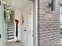 Inviting entryway featuring a gray brick exterior and a view of the modern staircase and stylish decor at 459 Blairhill Rd # 02, Charlotte, NC 28217