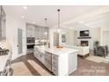 Stylish kitchen with an island, stainless steel appliances, and a view of the living room with a fireplace at 1228 Sage Pine Cir # 12, Clover, SC 29710